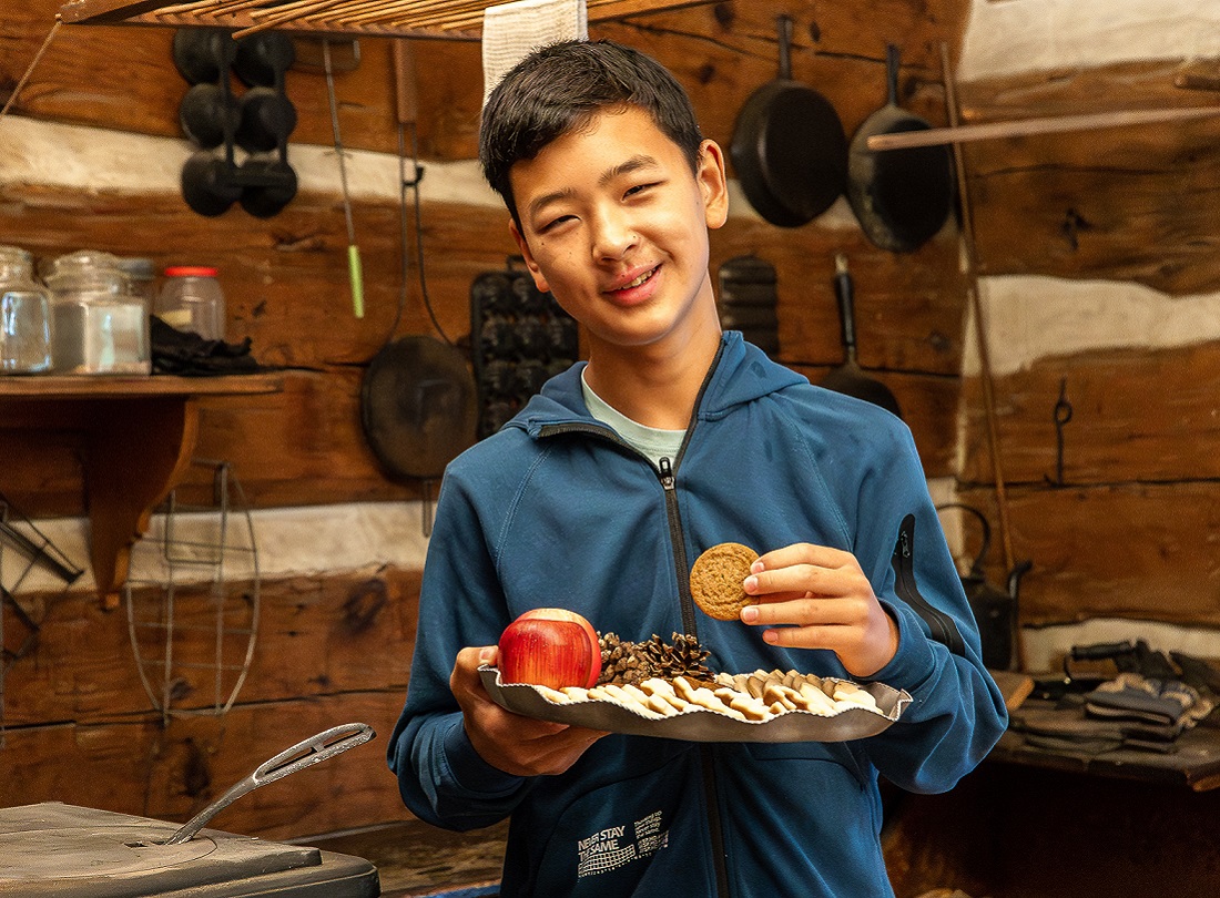Holidays at The Village 21 a student samples traditional Victorian festive treats during a holiday season school field trip to The Village at Black Creek