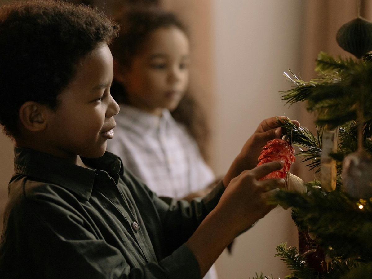 Holidays at The Village 15 youngsters place traditional Victorian holiday ornaments on a Christmas tree at The Village at Black Creek
