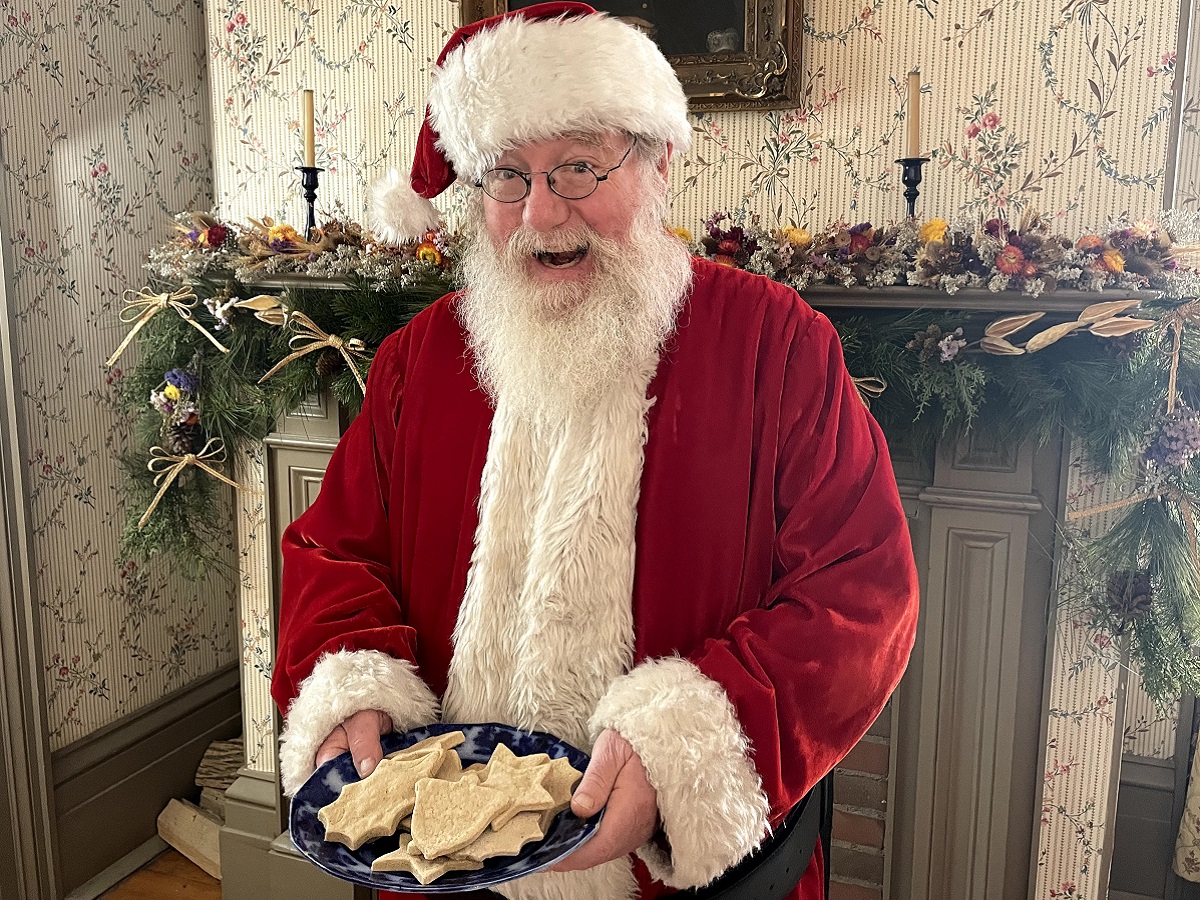 Holidays at The Village 16 Santa greets visitors to his workshop at The Village at Black Creek with a plate full of cookies