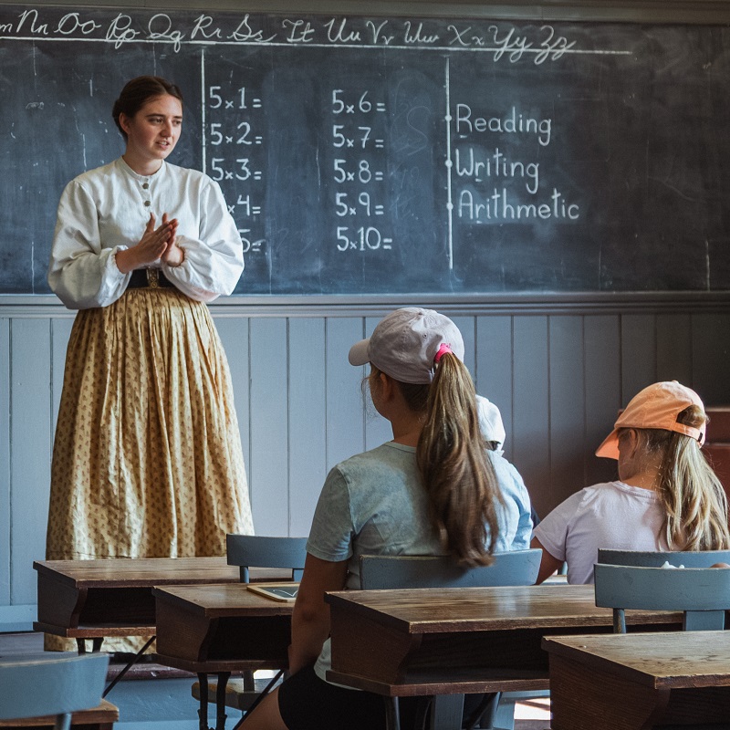 summer campers at The Village at Black Creek experience learning in a traditional one-room school house