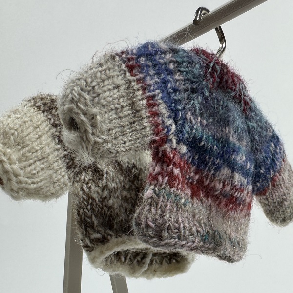a miniature sweater created by textile artist Wen Shen