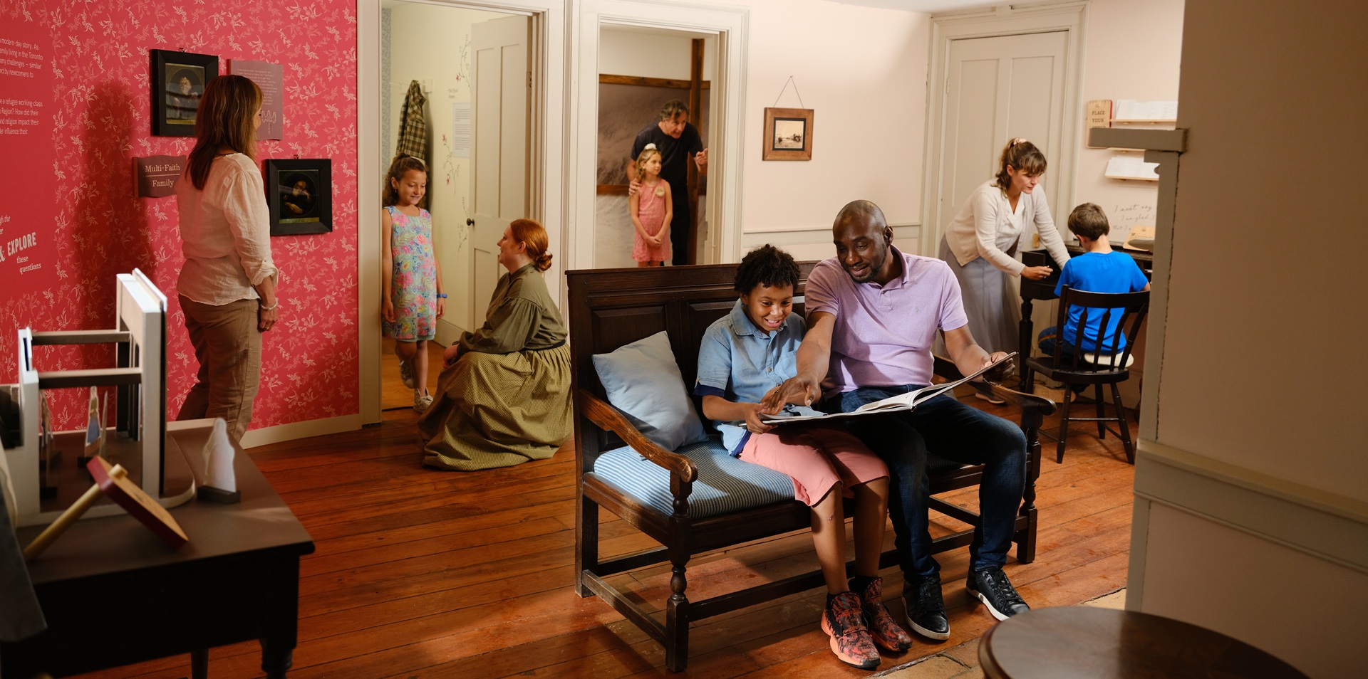 a family enjoys learning to play a Victorian board game during a weekend visit to The Village at Black Creek