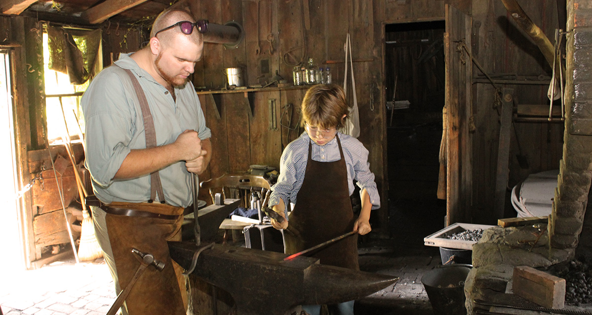 historic interpreter presents a demonstration at the Black Creek Pioneer Village blacksmith shop