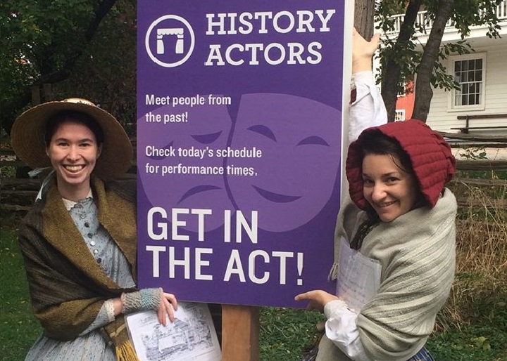 History Actors pose beside History Actors sign