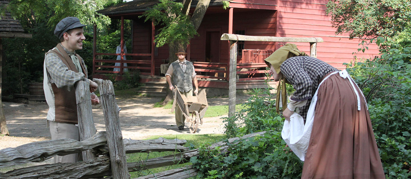 interpreters in period costume re-enact pioneer life